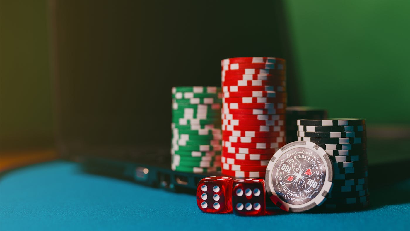 Dice and casino tokens representing multiplier odds and payout risk