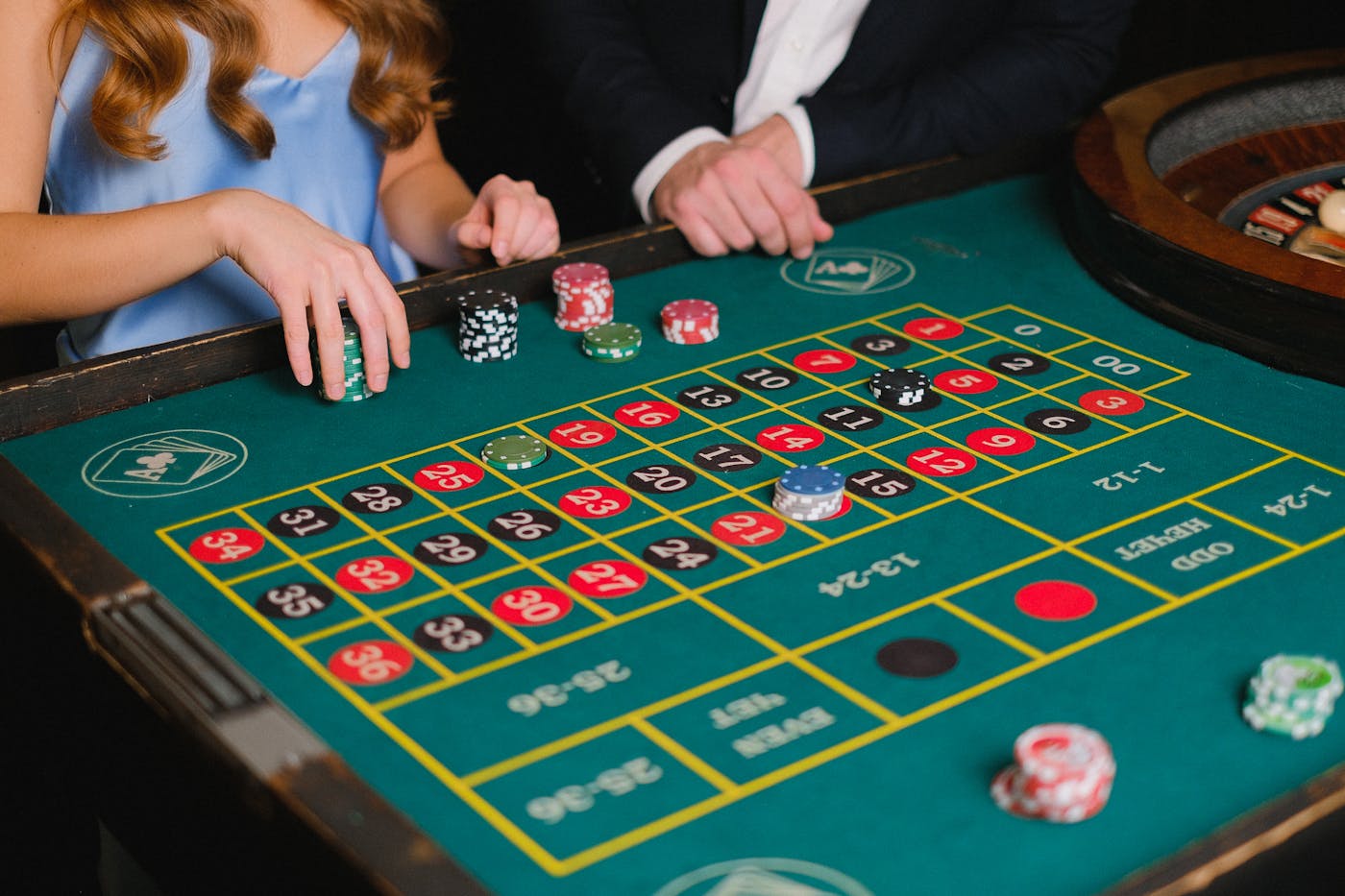 Hands placing casino chips on a roulette table representing transparent game outcomes